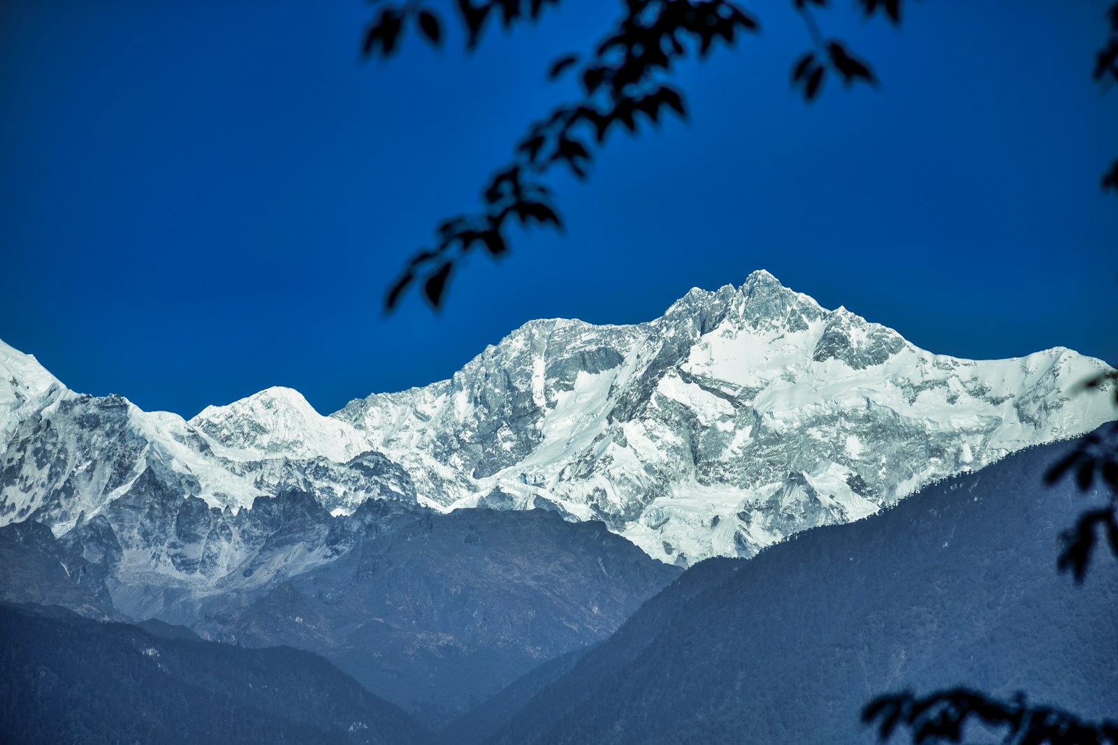 Snow covered mountain under blue sky during daytime in Pelling